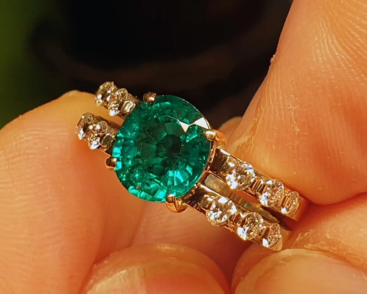750 Weißgoldring mit natürlichem Smaragd und 12 Brillanten